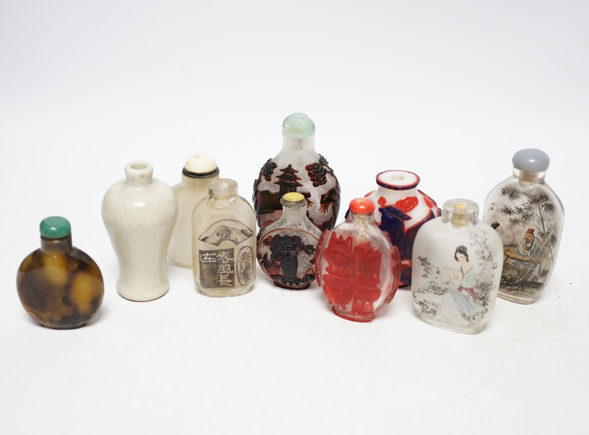 A group of Chinese cameo glass and inside painted glass and faux hardstone glass snuff bottles, largest 8.5cm high